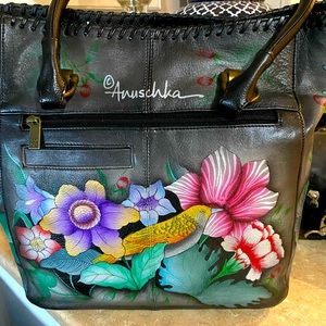 NWOT - Anuschka satchel complete with cosmetic bag and metal tag.